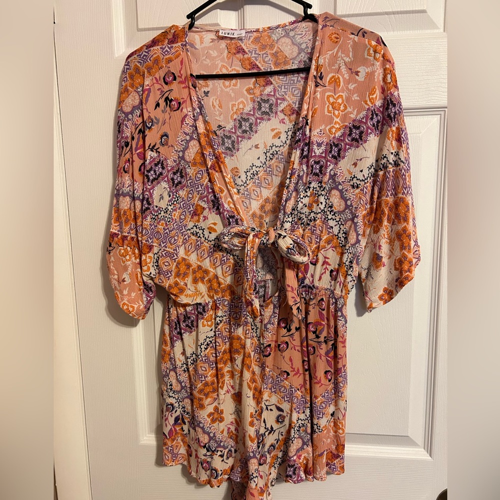 Size large romper. Never been worn.